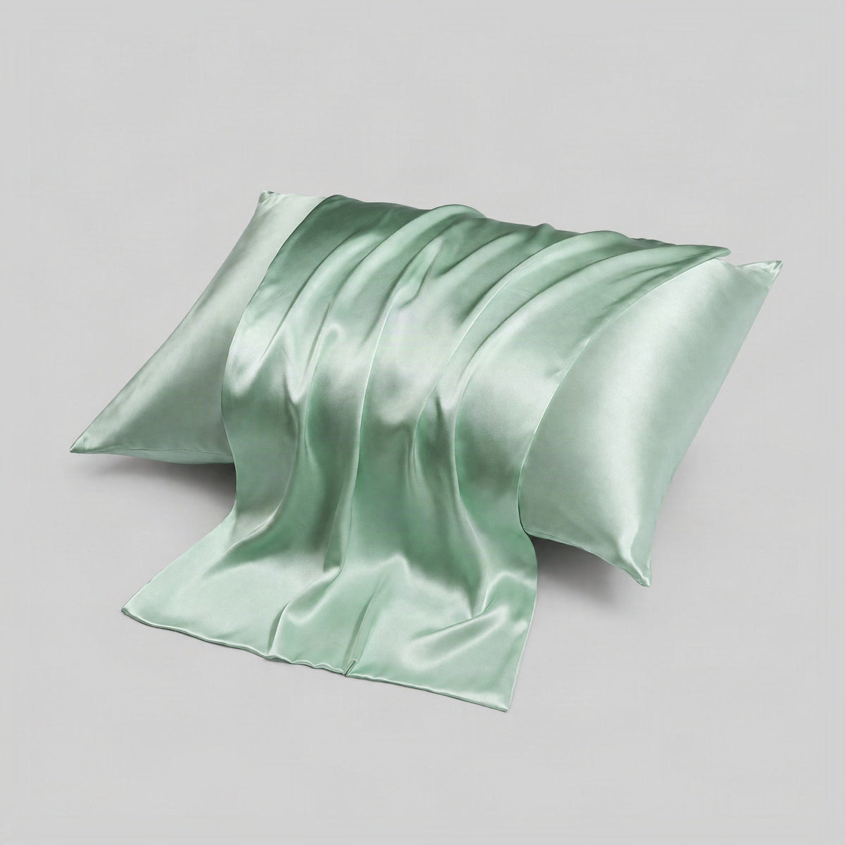 White SuuSilk 16 Momme mulberry silk pillowcase with hidden zipper, neatly arranged on a bed in soft natural light.