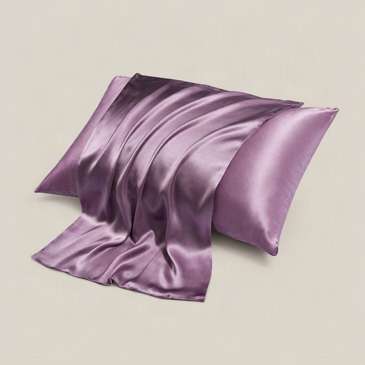 SuuSilk 16 Momme silk envelope pillowcase in soft blush pink, neatly arranged on a bed with matching linen sheets