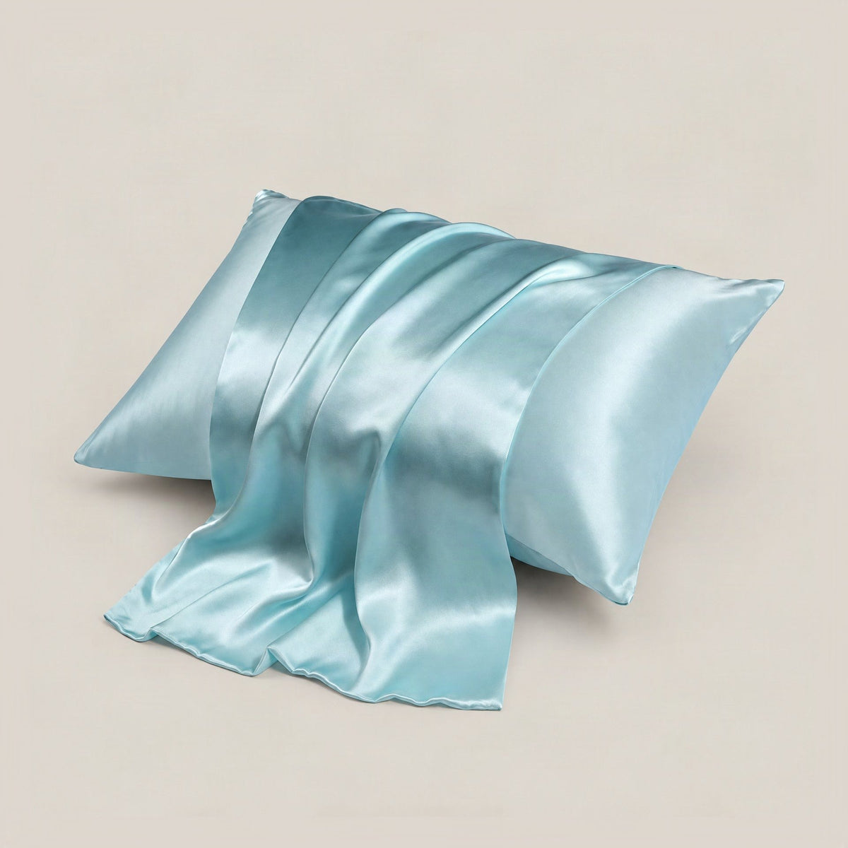 SuuSilk double-sided silk envelope pillowcase in soft pink, showing hidden closure detail on white bedding.