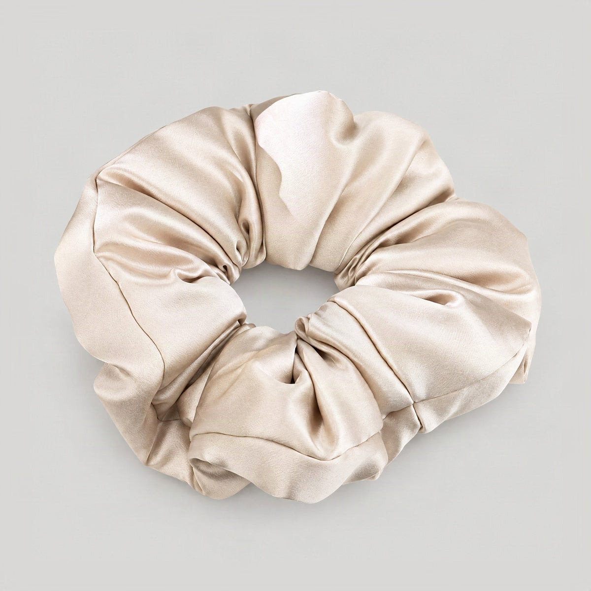 SuuSilk 30 Momme mulberry silk padded scrunchie in soft ivory, displayed against a neutral setting