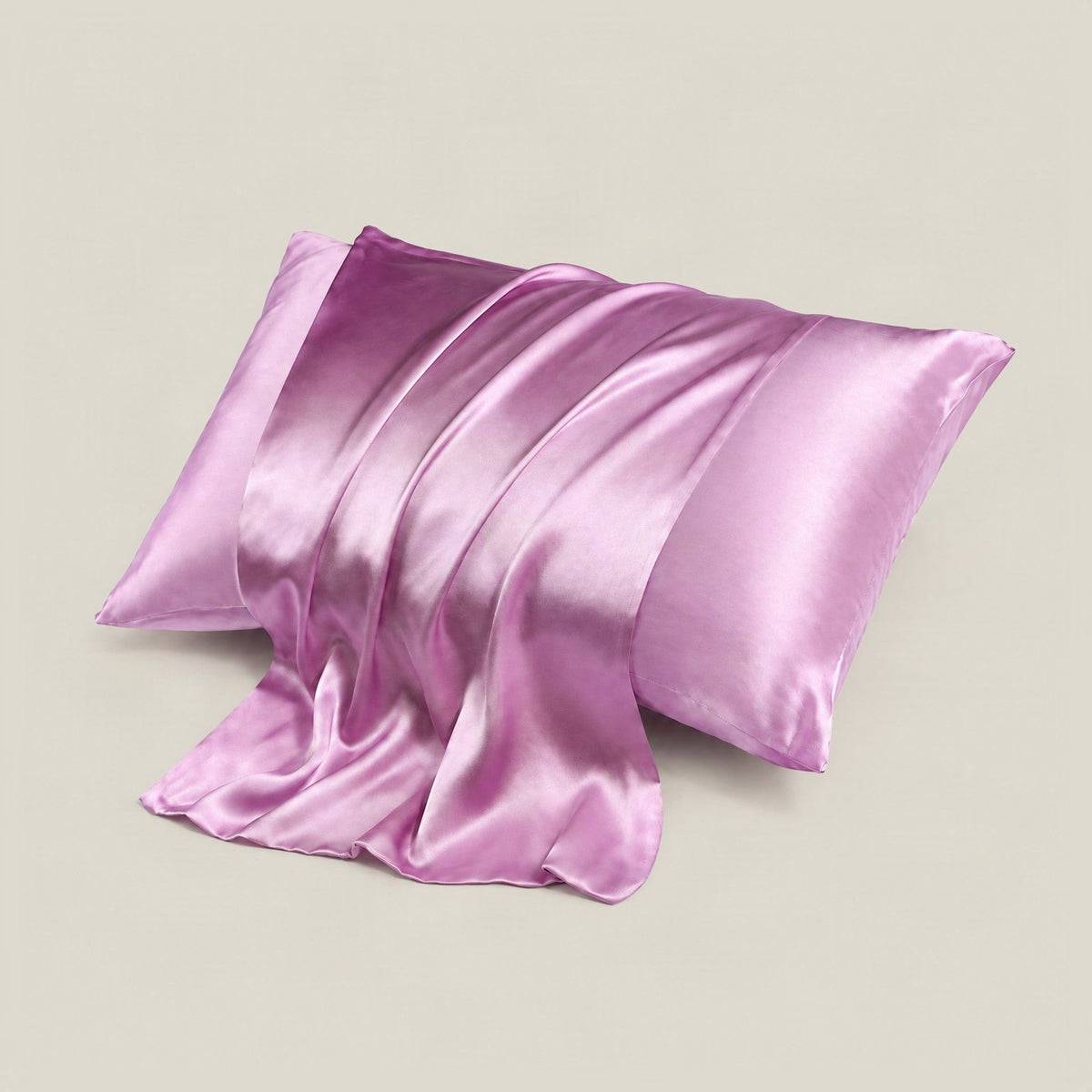 SuuSilk 16 Momme mulberry silk pillowcase in soft ivory, neatly arranged on a bed with hidden zipper detail visible