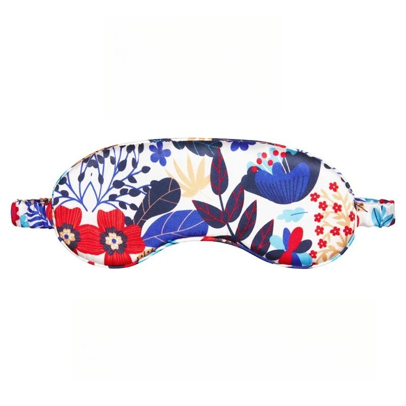 SUUMEE mulberry silk sleep eye mask in soft pink, gently resting on a bedside table in a cozy bedroom setting