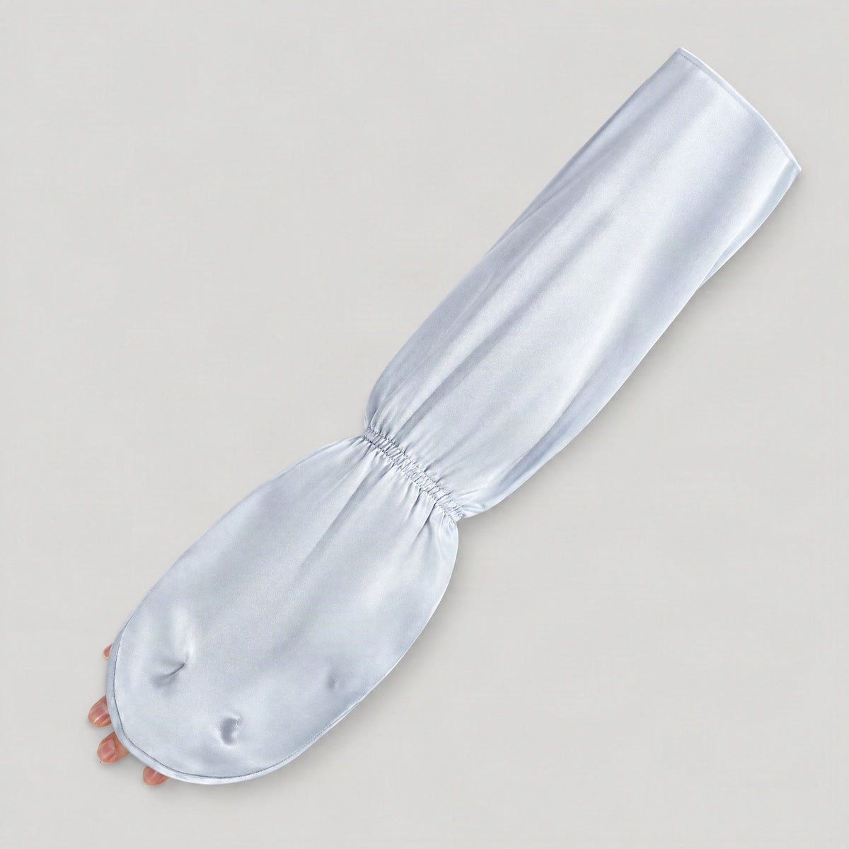 Light blue mulberry silk UV arm sleeve laid flat with the fingertip opening visible