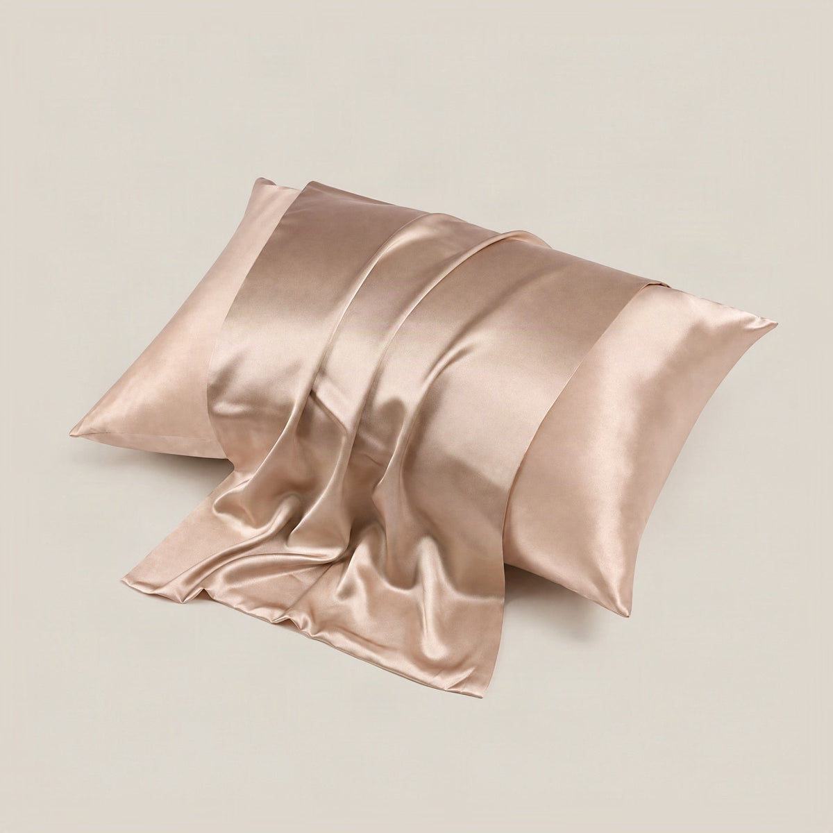 SuuSilk 22 Momme matte mulberry silk pillowcase in soft pink, folded on a neutral linen surface with hidden zipper detail.