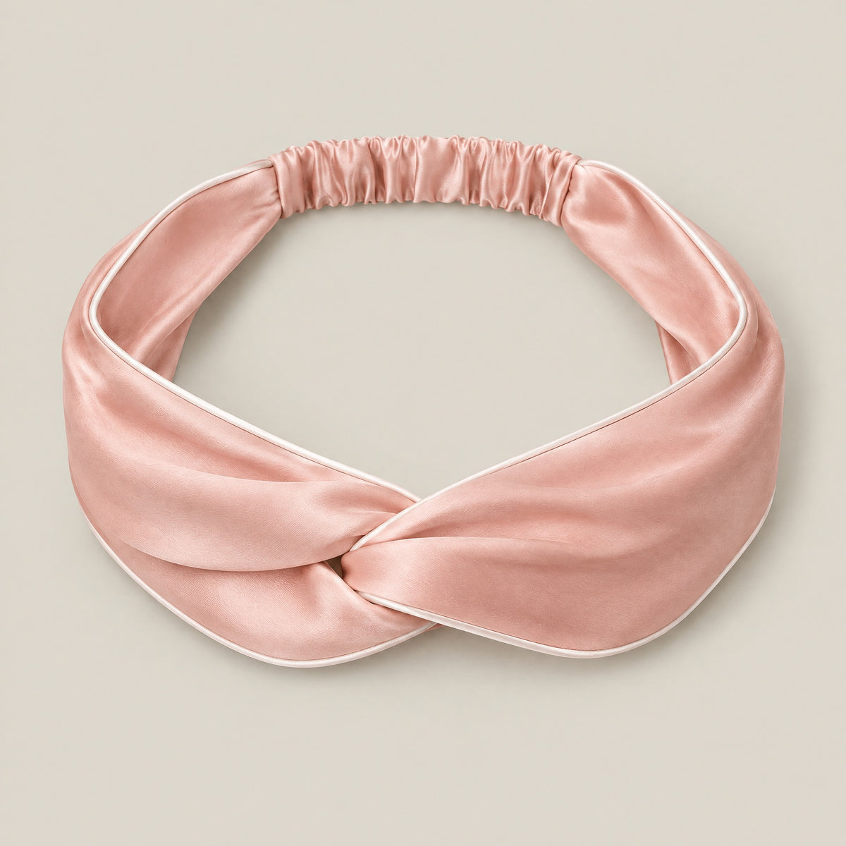 Mulberry silk twisted knot headband with piped edge, laid flat