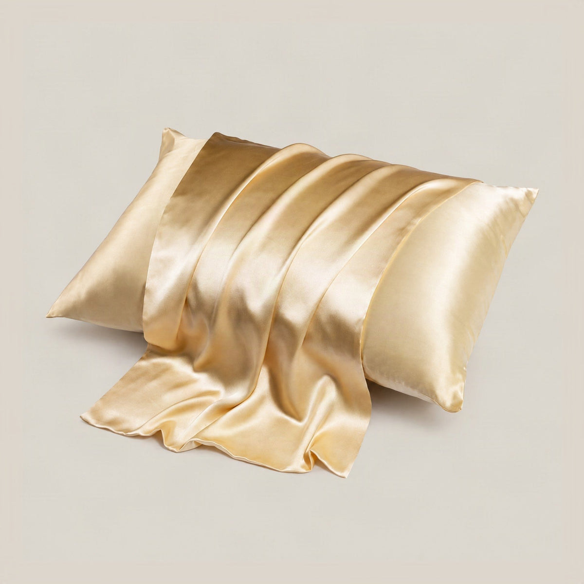 SuuSilk 16 Momme silk envelope pillowcase in soft pastel color draped on neutral linen bedding