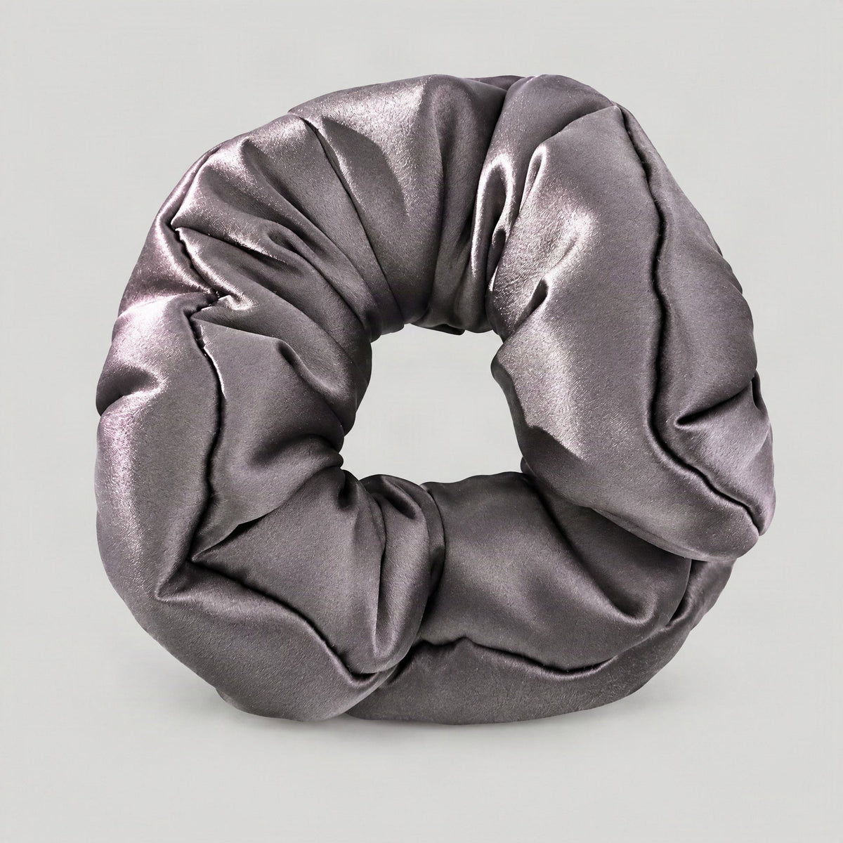 Mulberry silk scrunchie in neutral tone shown elegantly draped, highlighting its smooth texture and gentle hair-friendly desi