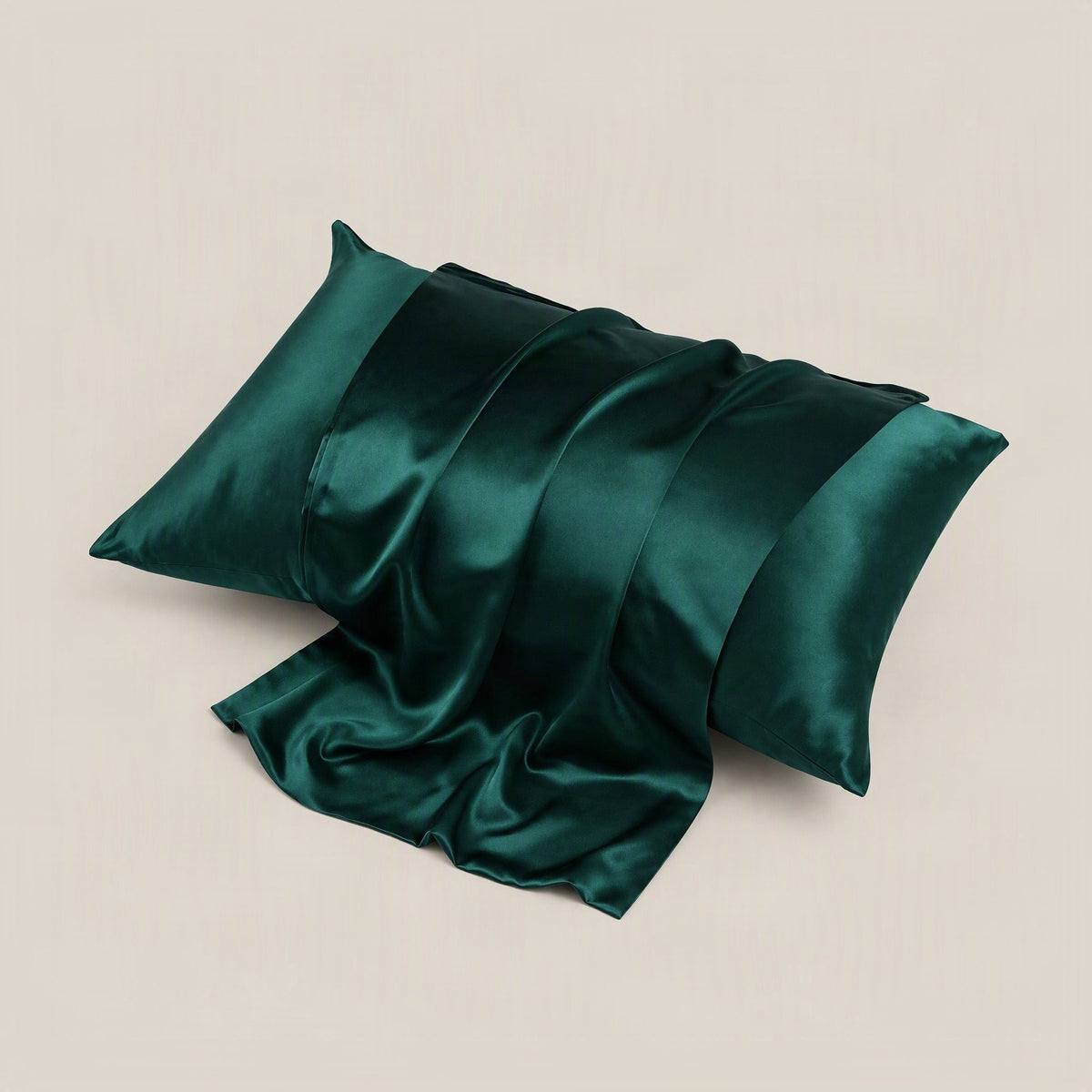 Mulberry silk pillowcase in soft blush tone draped on a bed, showing matte finish and hidden zipper detail.