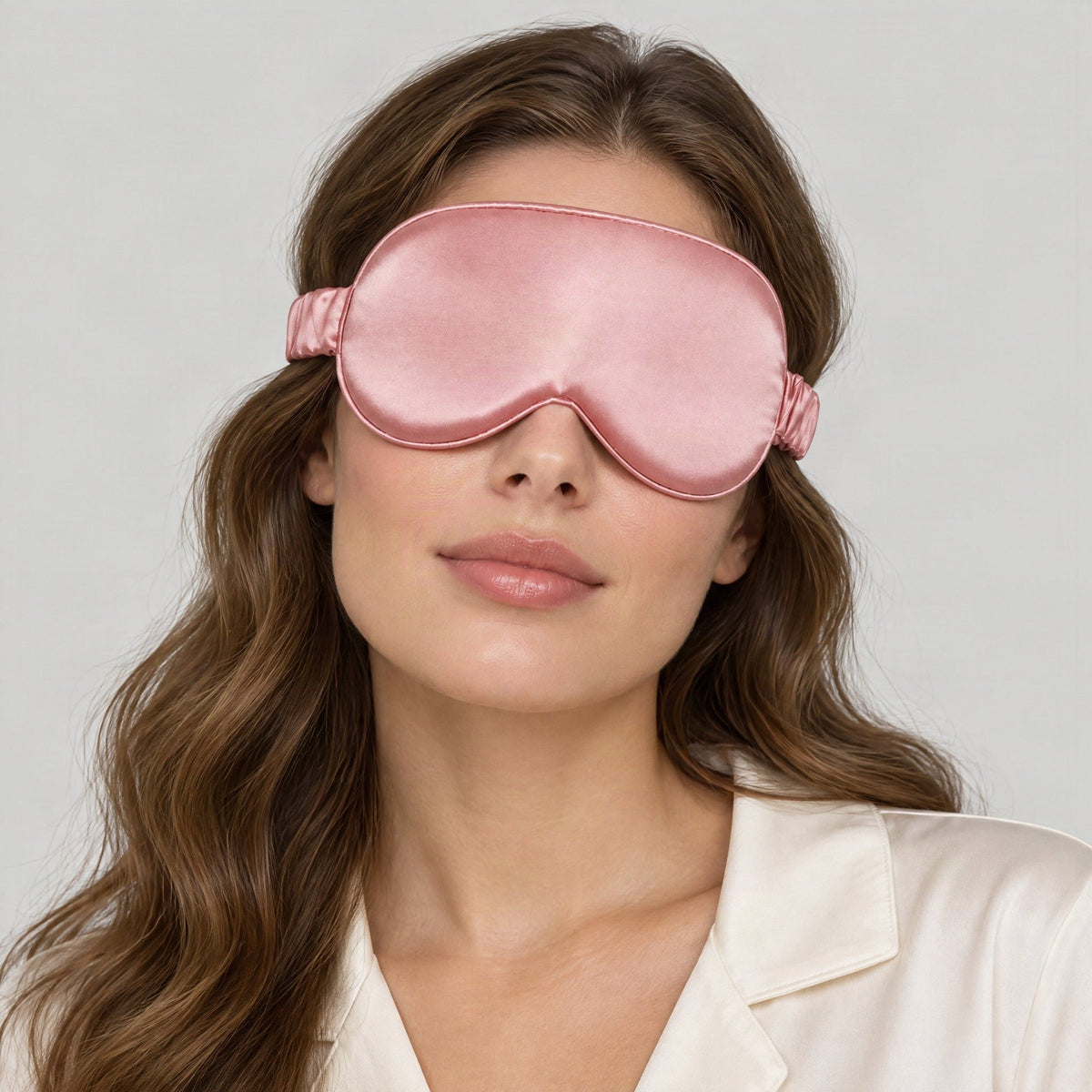 Pink 19 momme 3D contoured mulberry silk sleep eye mask worn by a model